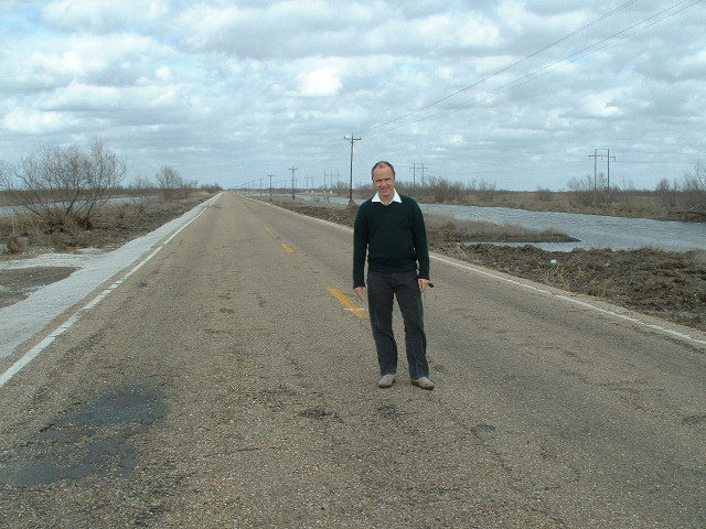 Jon on the road, giving scale to a desolate scene